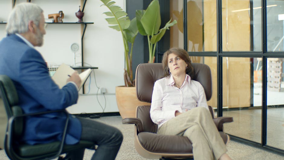 Therapist and client during a psychotherapy session in a modern office.